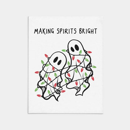 Two ghosts wrapped in Christmas lights with text 'Making Spirits Bright' on a white background